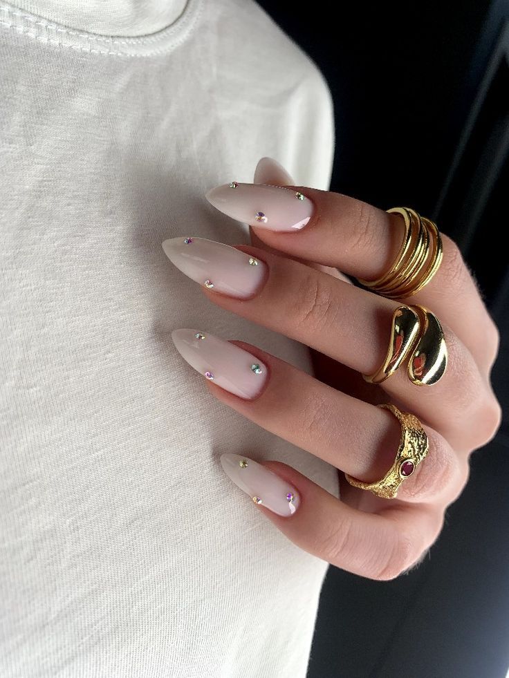 Chic Pastel Almond Nails with Rhinestones and Gold Rings for Effortless Glamour.