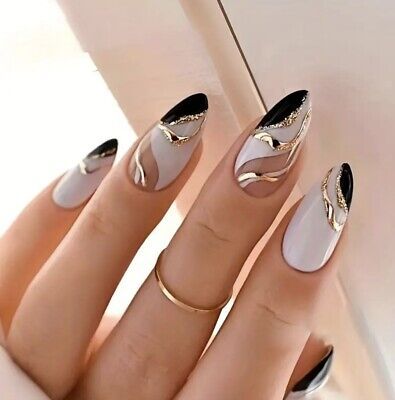 Sophisticated Nail Design with Black and Nude Shades and Luxurious Gold Accents.