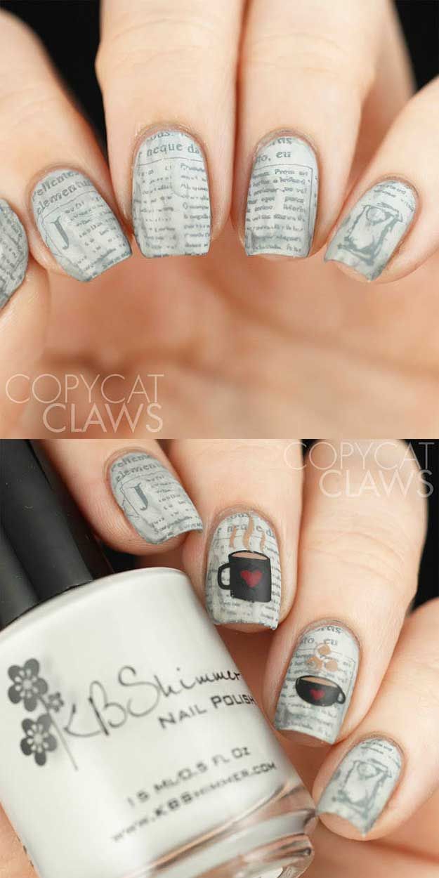 Playful Textured Nail Art: Glossy Grey Base with Illustrative Patterns and Symbols.