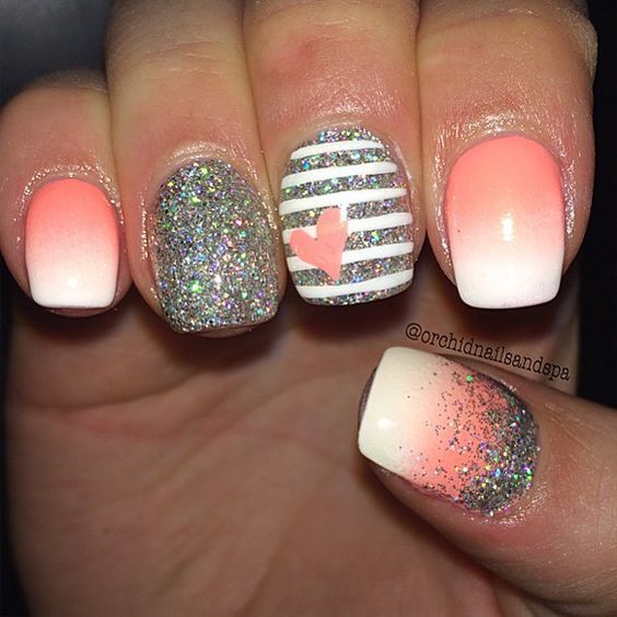 Elegant Ombre Nail Design with Peach and White Shades, Glitter Accents, and Playful Heart Motif.