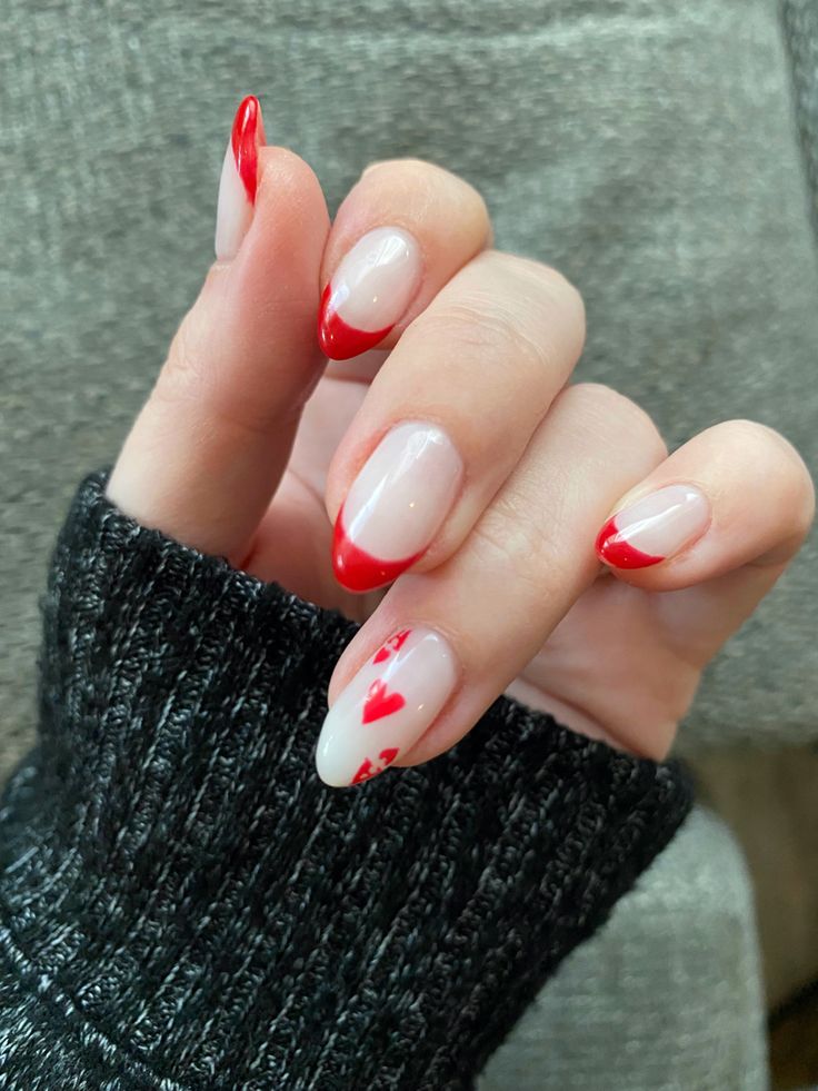 Romantic Nail Design: Nude and Red Tones with Heart Accents.