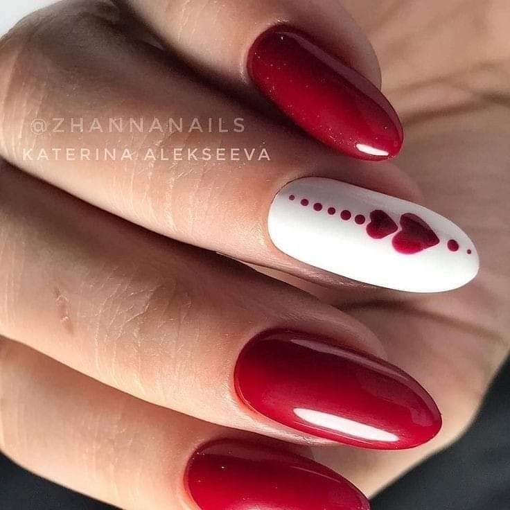 Sophisticated Deep Red Nail Design with White Heart Accent for Romantic Elegance.