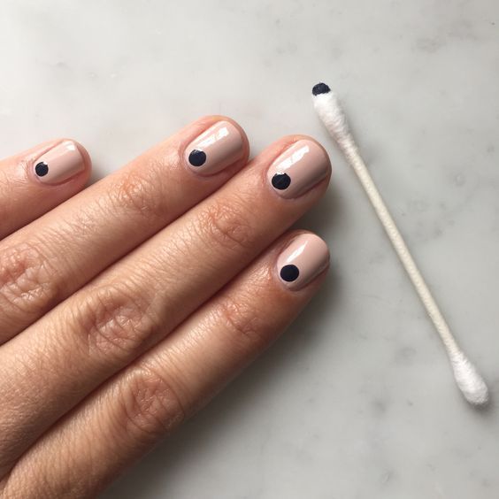 Chic Minimalist Nude Nails with Sophisticated Black Dot Accents