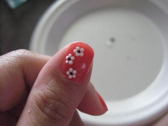 Cheerful Coral Nail Design with Delicate White Floral Accents