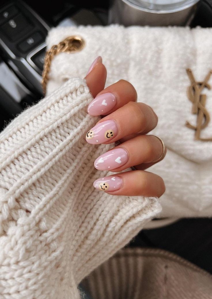 Charming Soft Pink Nail Design with Whimsical Heart and Smiley Accents