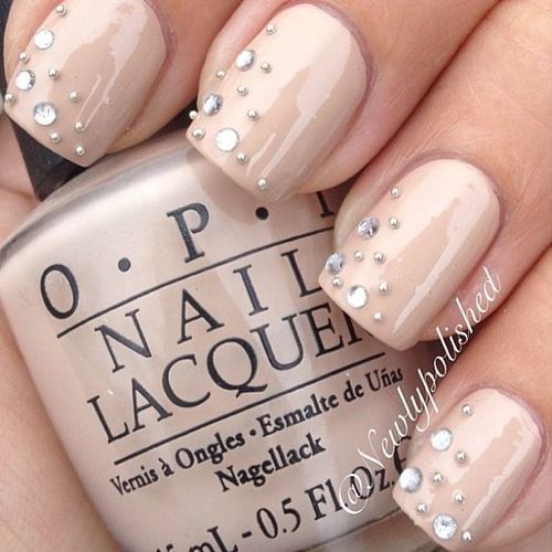 Sophisticated Elegance: Nude Nails with Delicate Rhinestone Accents