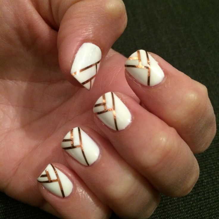 Sophisticated Geometric Nail Art: Elegant White Base with Metallic Gold Stripes.