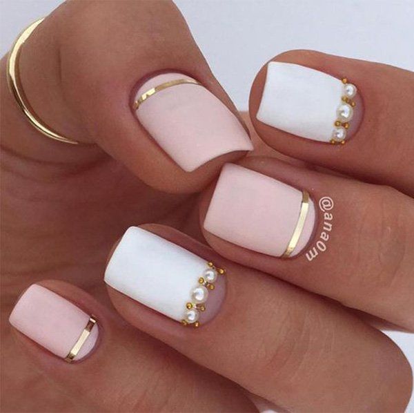 Elegant Chic Nail Design: Soft Pastel Pink and White with Gold Accents and Pearl Embellishments