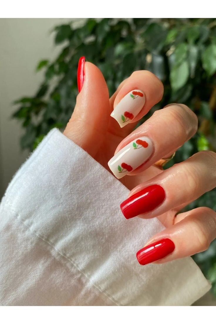 Vibrant Red Cherry Motif Nail Design on Neutral Base for a Cheerful Aesthetic.