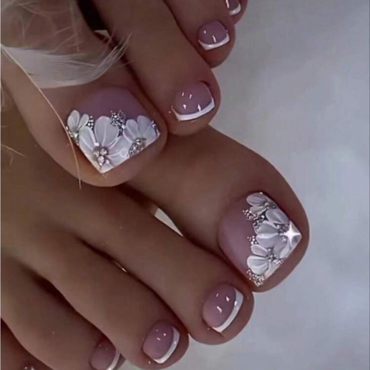 Chic Floral Pedicure with Soft Pink Tones, Delicate White Flowers, and Glamorous Silver Accents.