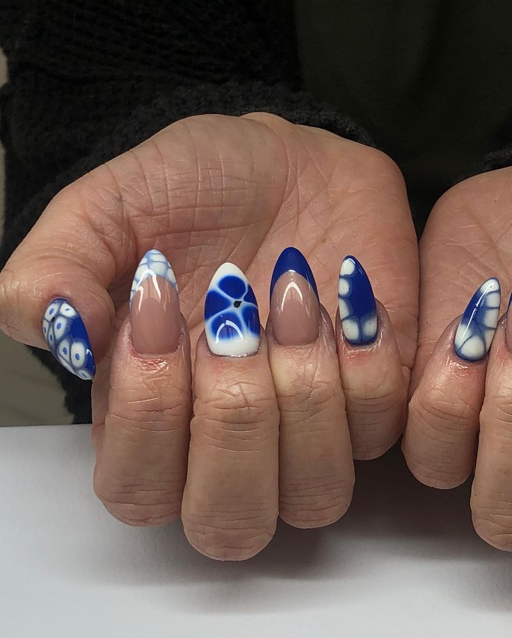 Striking Vibrant Blue and White Almond-Shaped Nail Design with Intricate Patterns