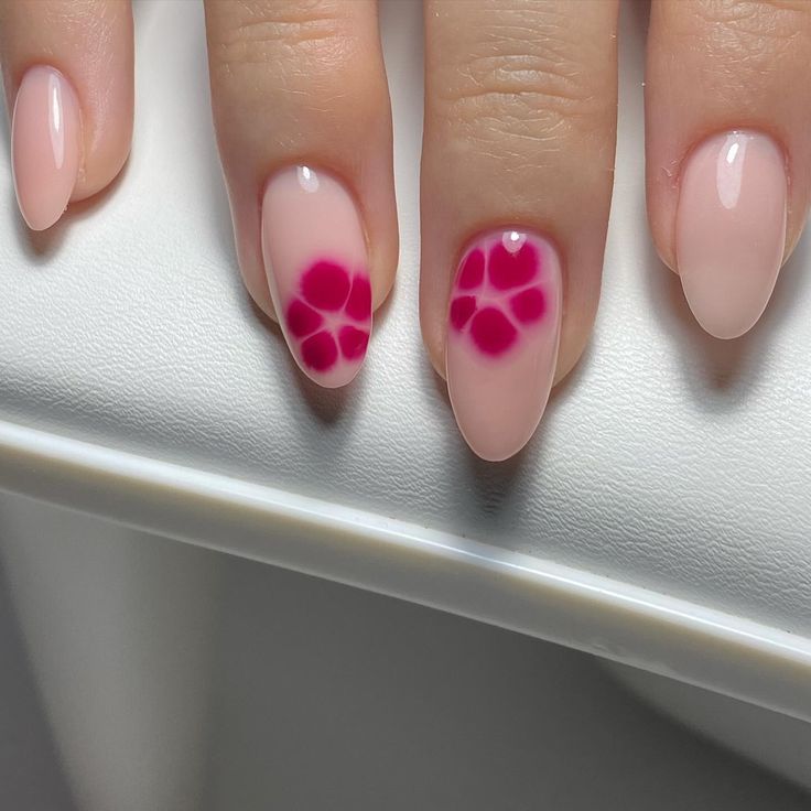 Chic Floral Nail Design: Soft Pink Base with Bold Fuchsia Accents.