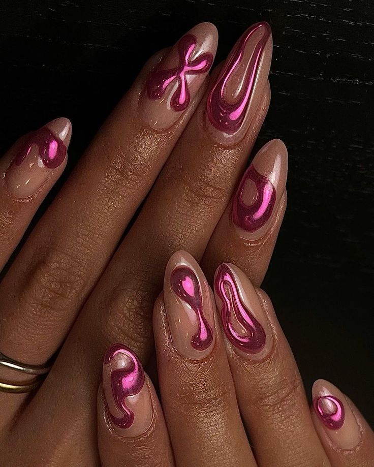 Chic Nail Design: Glossy Nude Meets Vibrant Metallic Pink with Artistic Swirl Pattern.