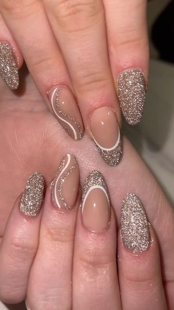 Glamorous Nail Design: Elegant Blend of Nude and Sparkling Tones with Artistic Detailing.