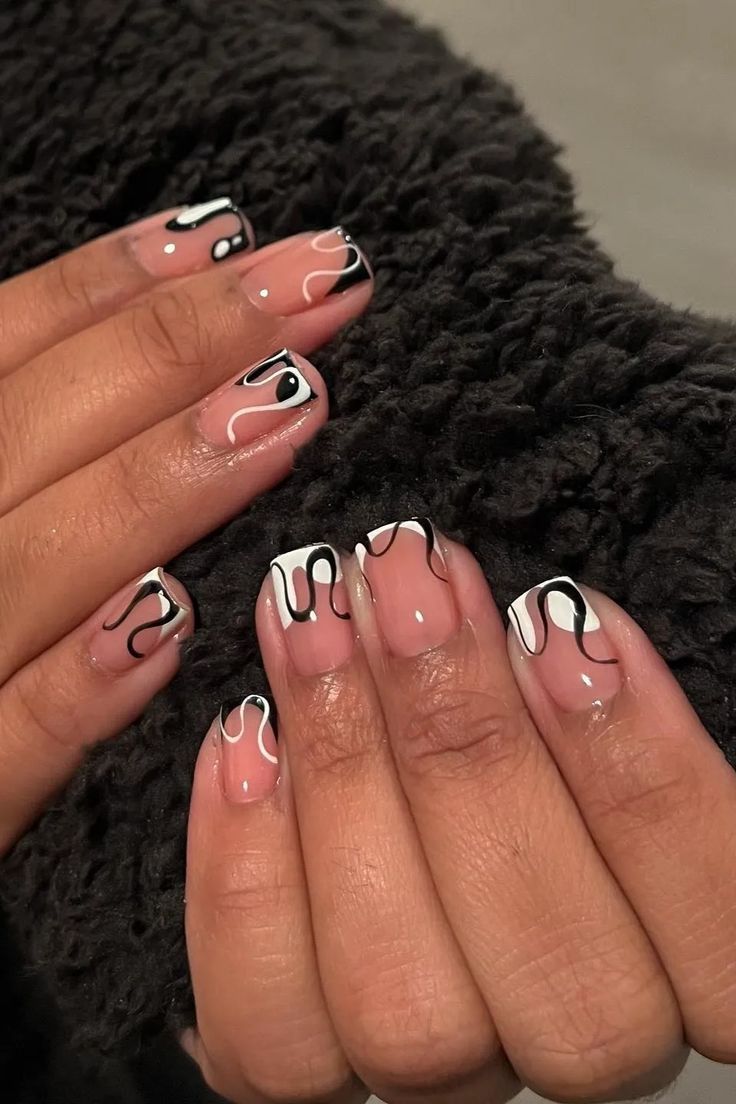 Abstract Black and White Swirl Nail Art: A Chic Blend of Elegance and Modern Flair.