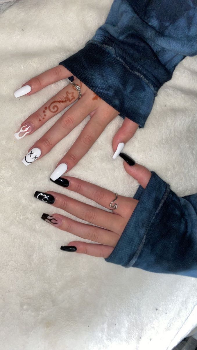 Bold Black and White Nail Design with Artistic Accents and Intricate Henna Patterns.