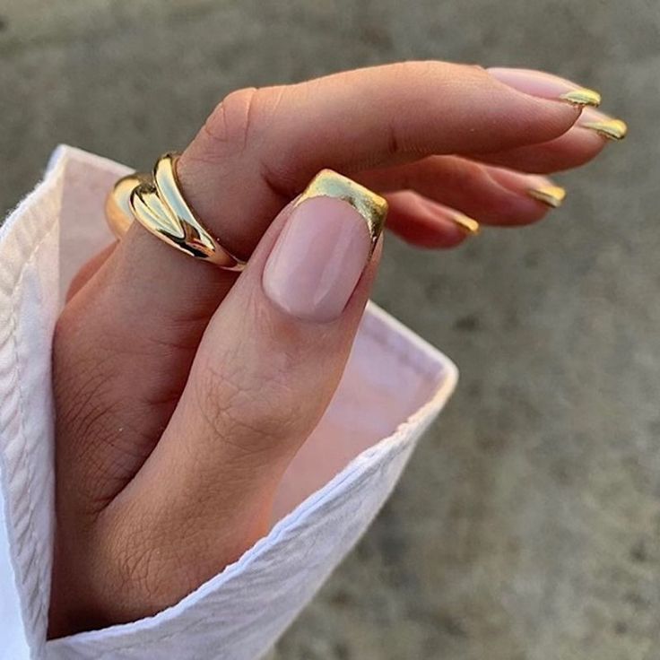 Chic Gold-Tipped Nail Design with Elegant Nude Base and Delicate Ring Accents.