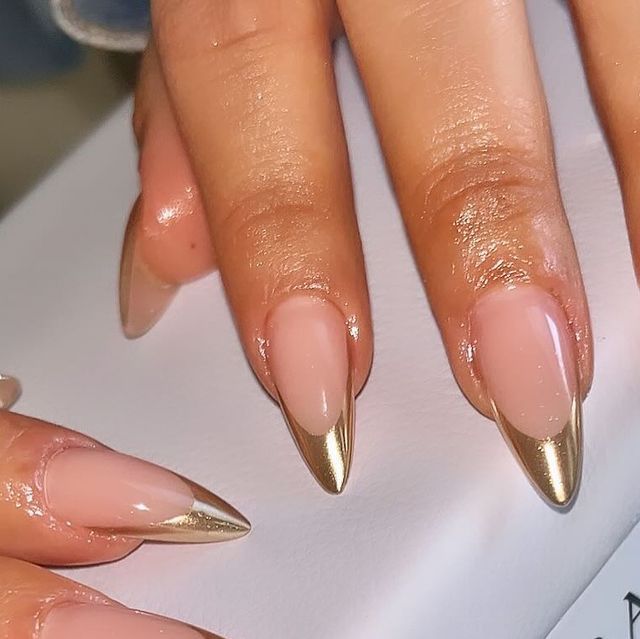 Chic Nude Stiletto Nails with Glamorous Gold Metallic Tips.