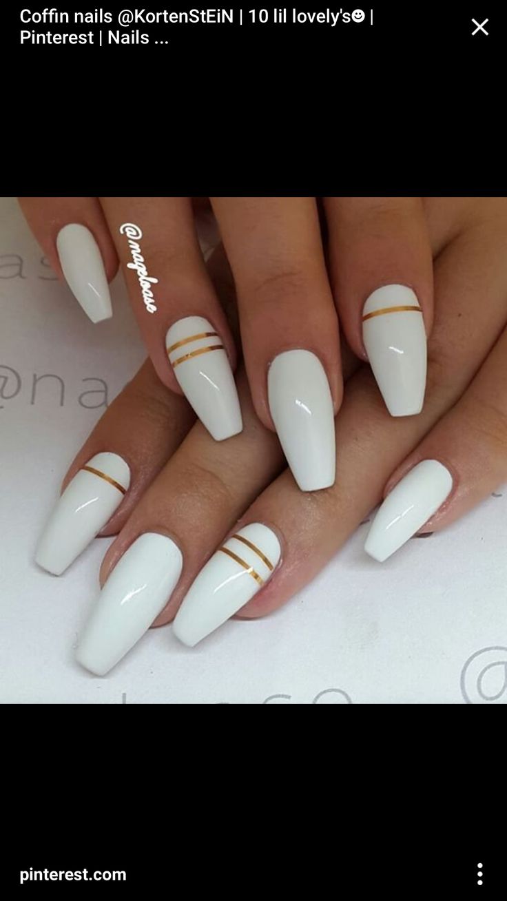 Elegant Coffin-Shaped Nails with Pristine White Polish and Sophisticated Gold Stripes.