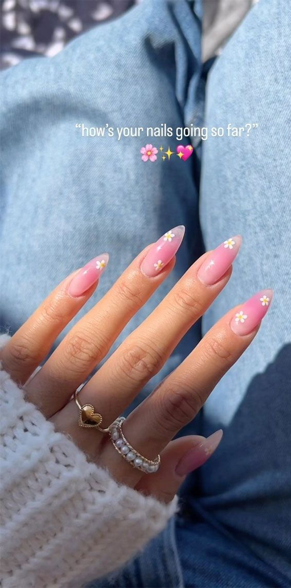 Chic Almond-Shaped Nail Design: Soft Pink Base with Delicate Floral Accents for a Playful Spring Aesthetic.