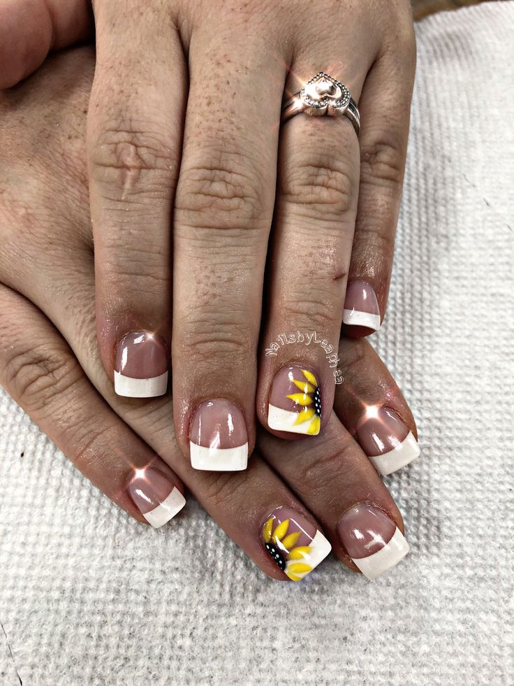 Chic French Manicure with Artistic Sunflower Detailing: A Perfect Blend of Sophistication and Playfulness.