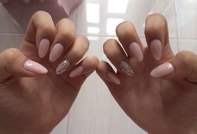 Chic Almond-Shaped Nails with Nude Base and Glitter Accents for Sophisticated Elegance.