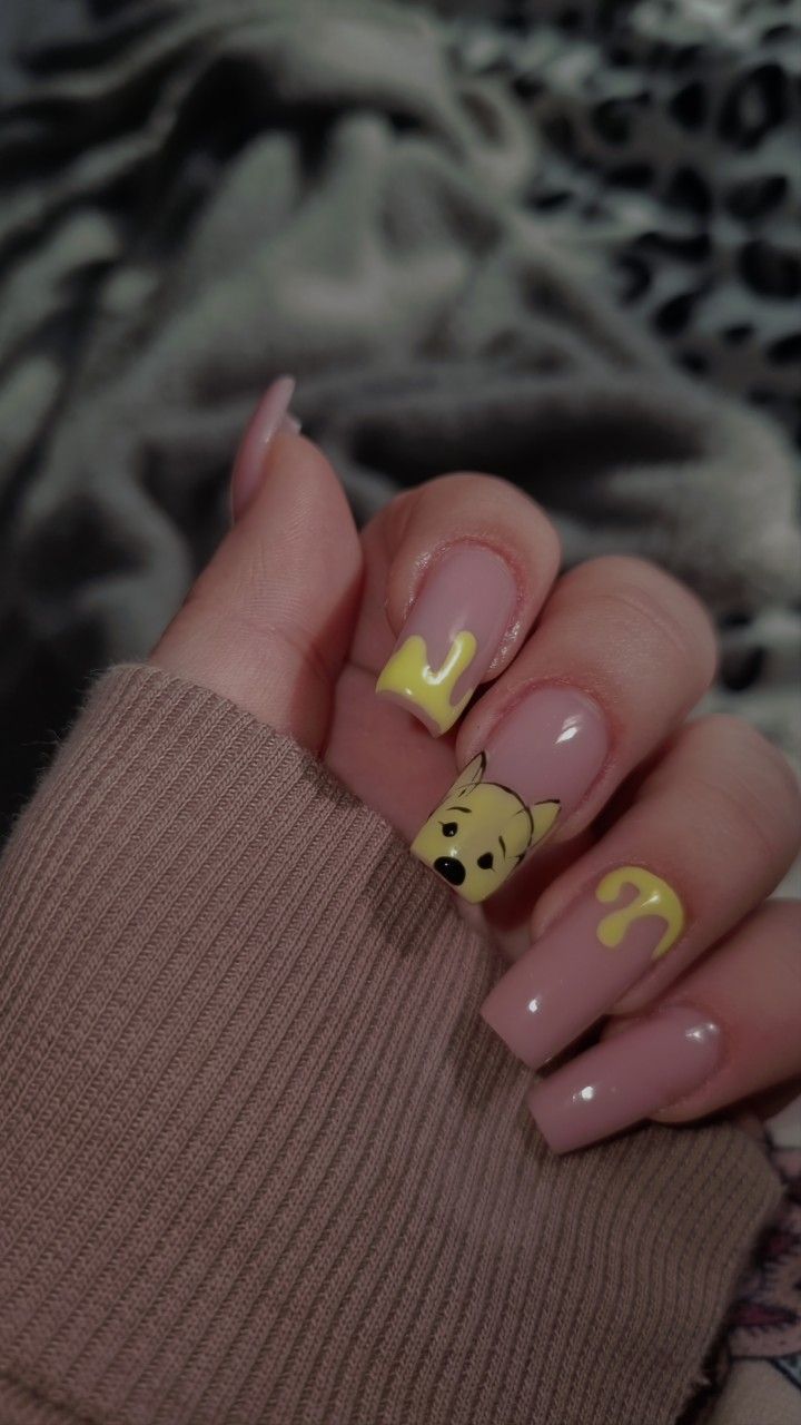 Playful Character Nail Design with Nude Base and Vibrant Yellow Accents