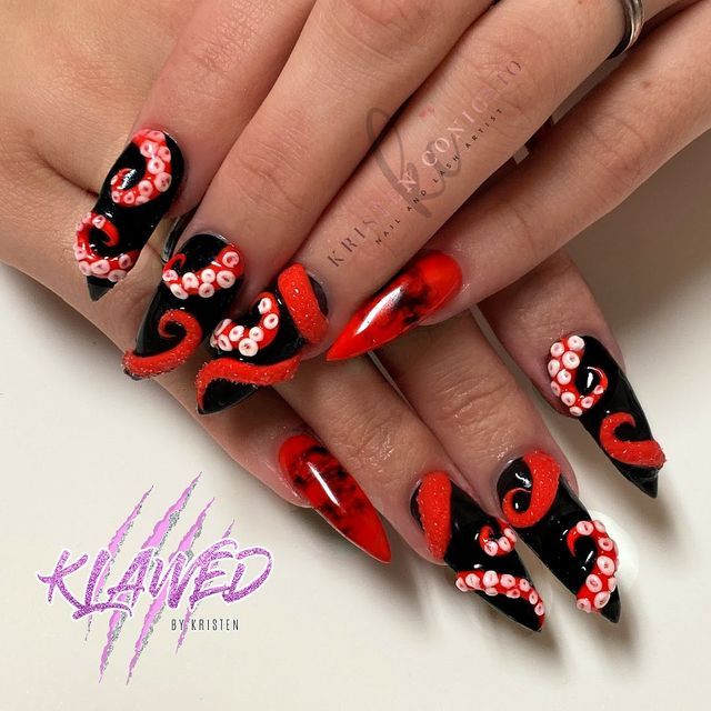 Bold Octopus-Inspired Nail Design with Dramatic Black and Red Color Scheme and Unique Tentacle Details.