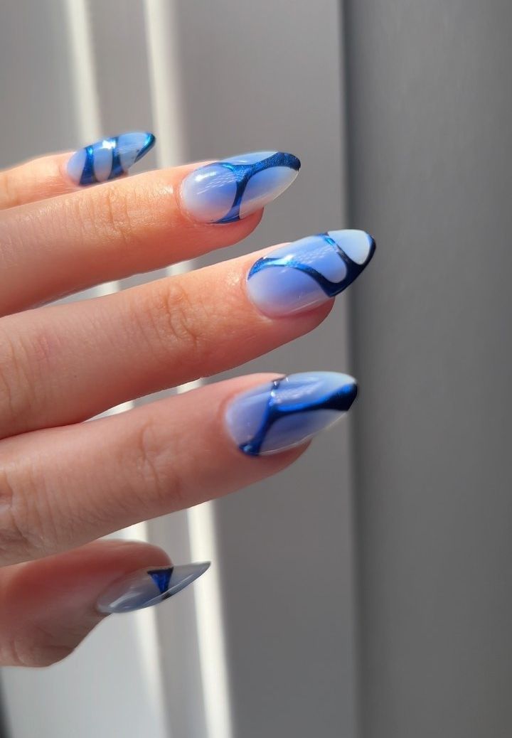 Serene Abstract Nail Design: Gradient Blue Hues with Elegant Black Lines