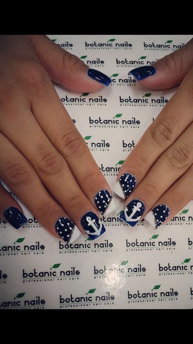 Nautical-Inspired Nail Design: Deep Navy Blue with White Polka Dots and Anchors for a Playful Touch.