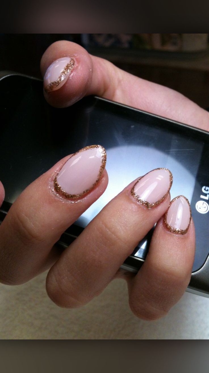 Sophisticated Soft Pink Nail Design with Shimmering Gold Outline.