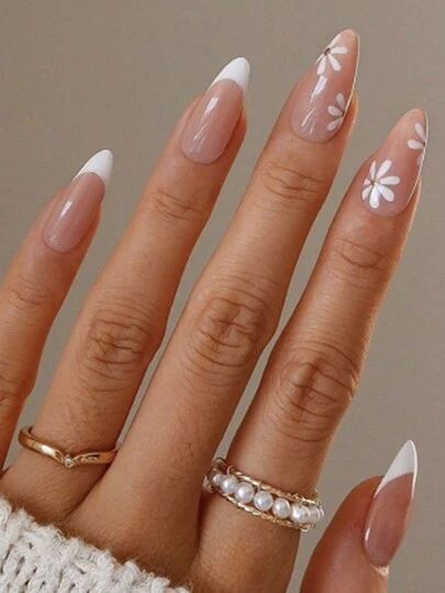 Chic Almond-Shaped Nail Art with French Tips and Daisy Patterns for a Trendy Elegance.