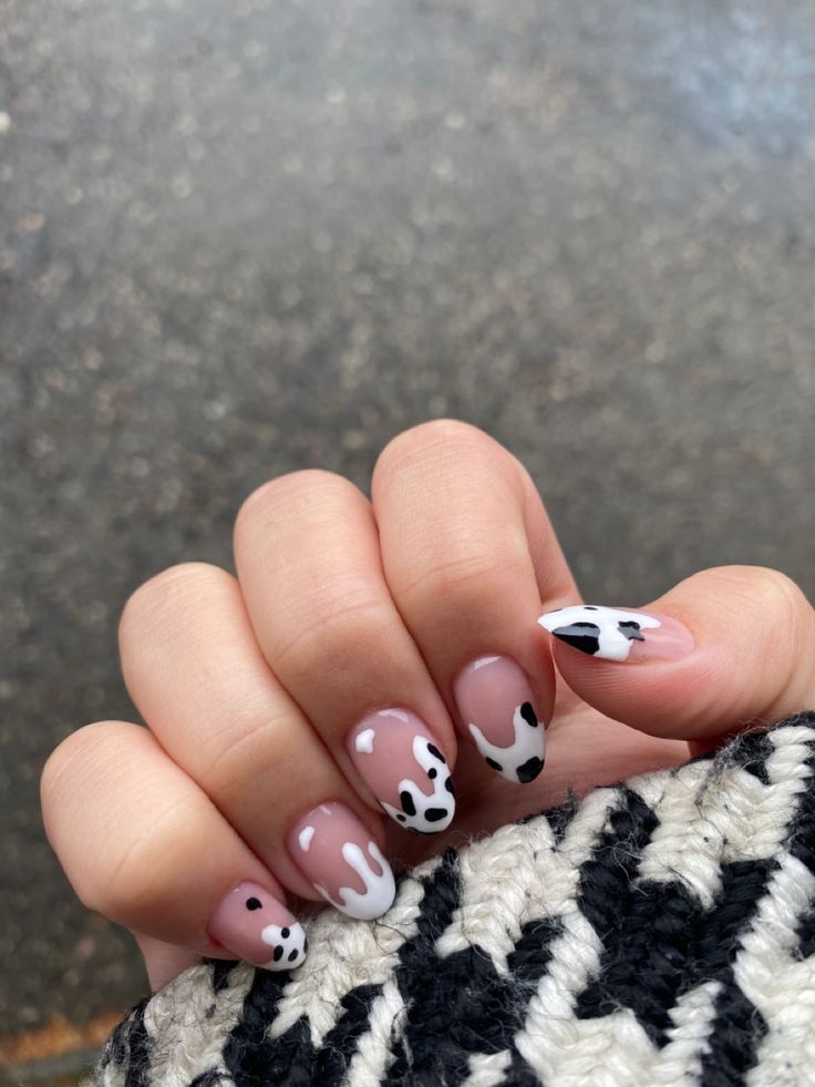 Whimsical Cow Print Nail Design with Glossy and Matte Finishes on a Nude Pink Base.