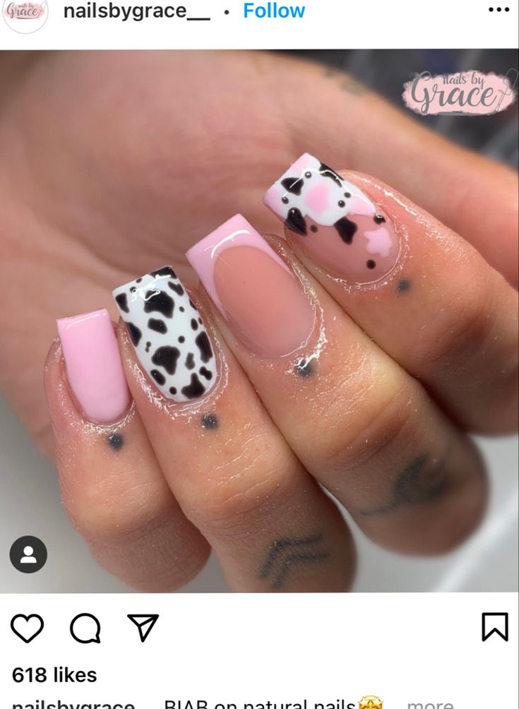 Chic Pink and Black Nail Design with Whimsical Cow Print Accents