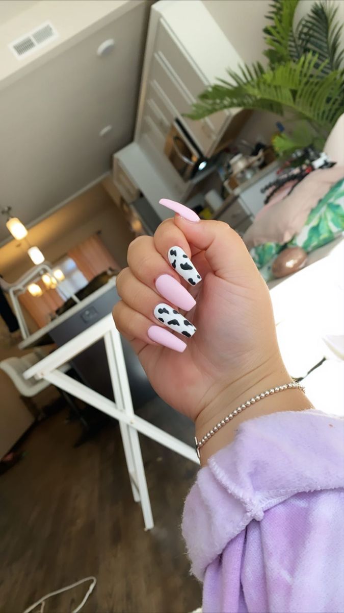 Whimsical Cow Print and Soft Pink Almond Nail Design