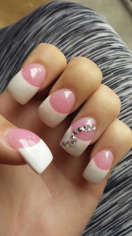 Stylish Chic Nail Design with Glossy White Tips, Soft Pink Accents, Polka Dots, Glitter, and Rhinestones.