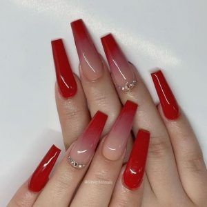 Vibrant Ombre Nail Design: Bold Red and Soft Nude with Elegant Cuticle Embellishments.