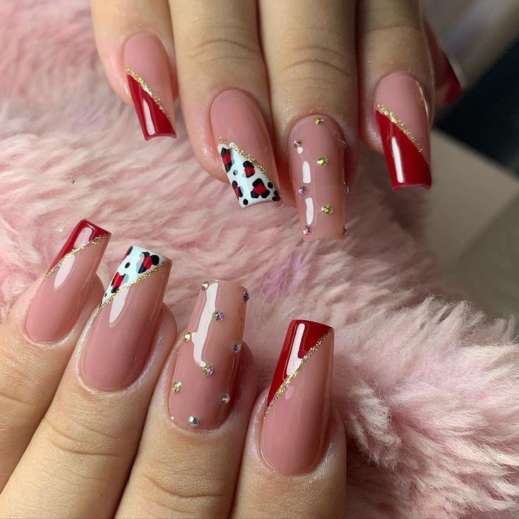 Chic Nail Design: Nude and Bold Red with Gold Accents and Polka Dots