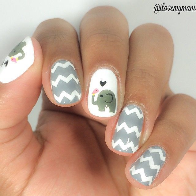 Playful Elephant-Inspired Chevron Nail Design with Charming Colors and Intricate Details.