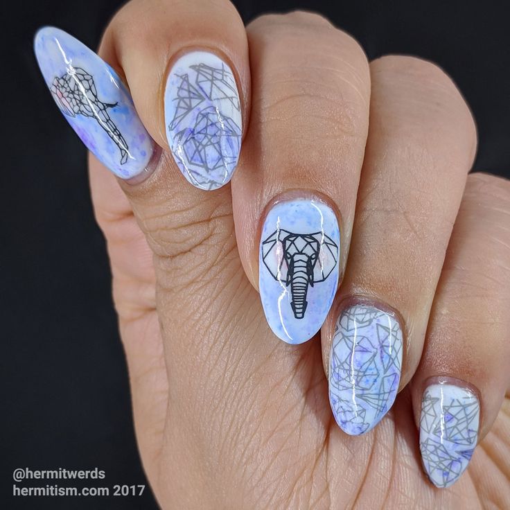 Pastel Blue and White Intricate Nail Design with Geometric Patterns and Artistic Elephant Motif.