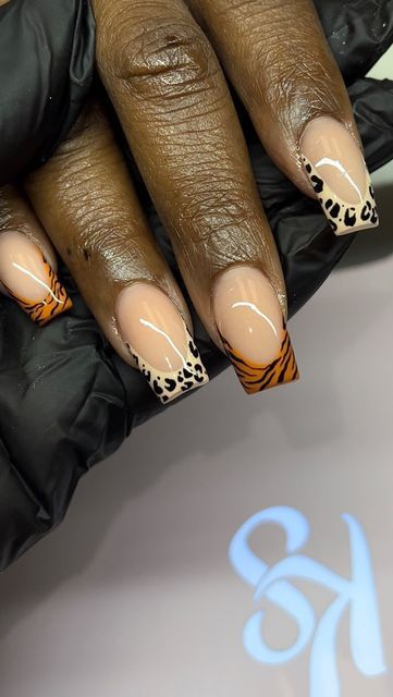 Trendy Nail Design: Elegant Nude Base with Vibrant Orange and Classic Leopard Tips