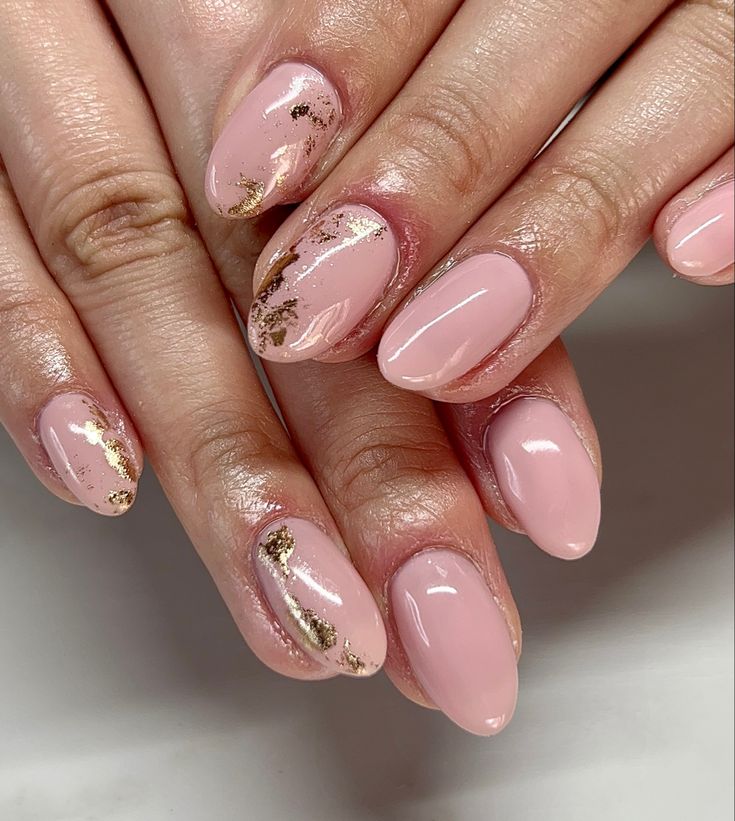 Sophisticated Elegant Pink Nail Design with Glossy Finishes and Gold Accents.