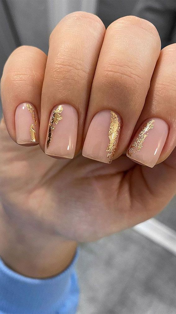 Sophisticated Nude Nail Design with Striking Gold Accents