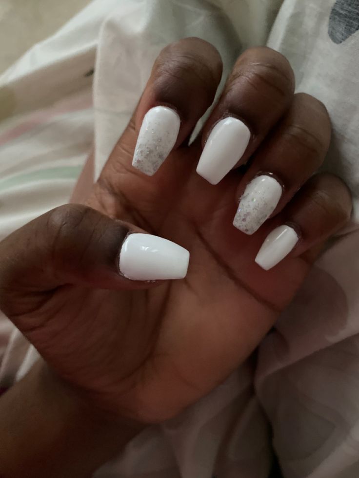 Elegant White Manicure: Glossy Square Nails with Subtle Glitter Accents.