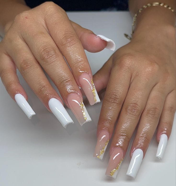 Sophisticated Nude and White Nail Design with Glossy Finish and Gold Accents.