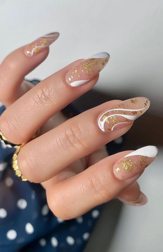 Chic and Modern Nude and White Nail Design with Glamorous Gold Foil Accents.