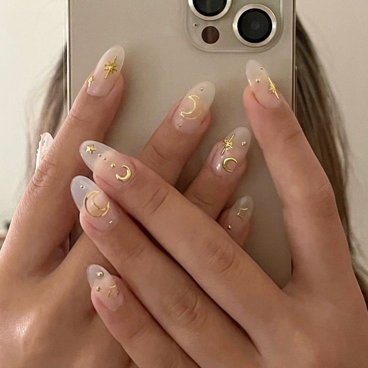 Elegant Celestial Nail Art with Sheer Base and Gold Accents