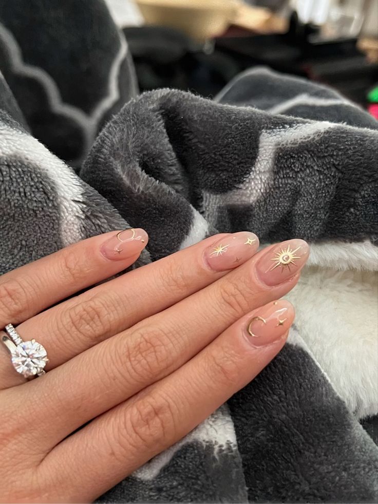 Whimsical Celestial Nail Design: Elegant Nude Base with Gold Accents