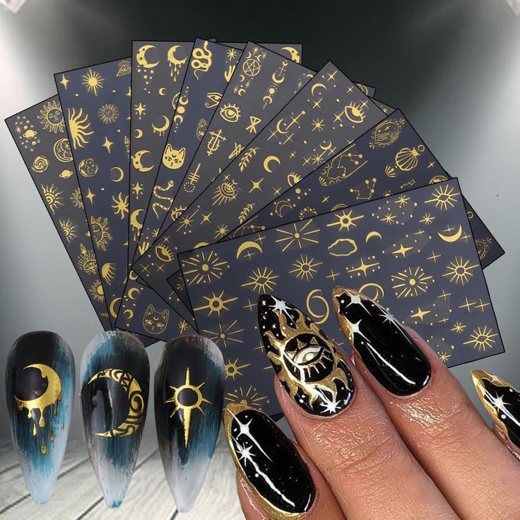 Enchanting Celestial Nail Design: Intricate Gold Patterns on Deep Black with Ombre Gradient