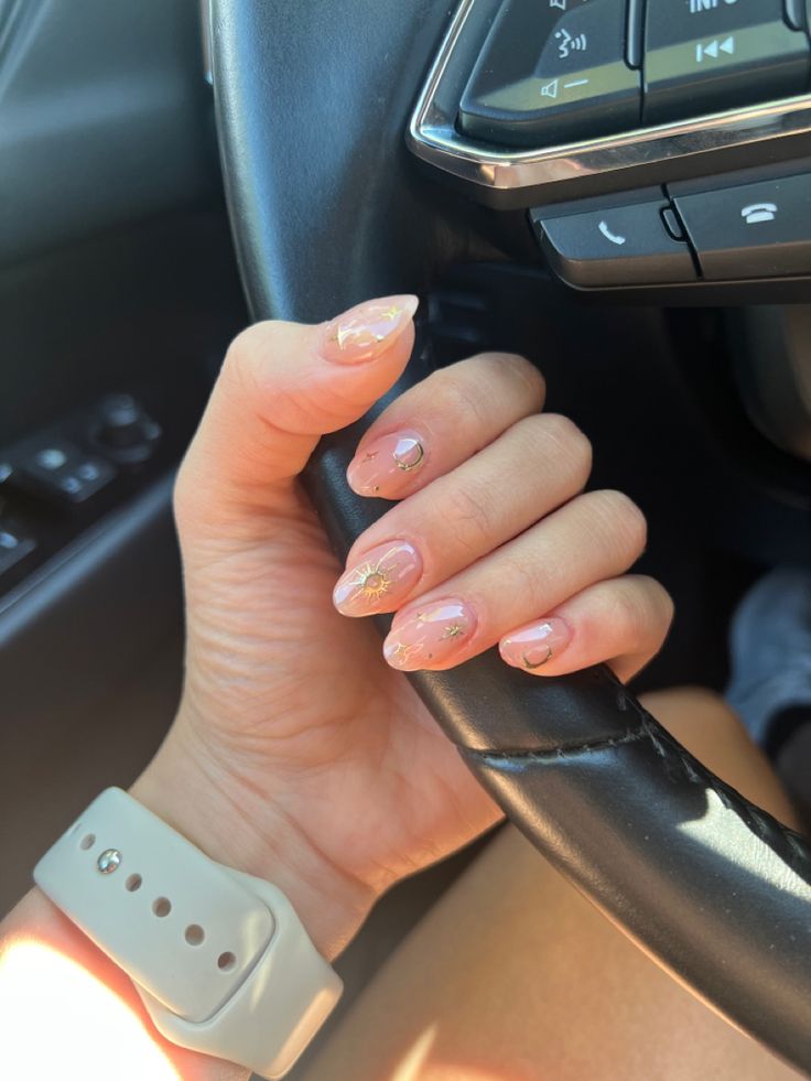 Elegant Nude Nail Design with Delicate Gold Accents and Subtle Gemstones.